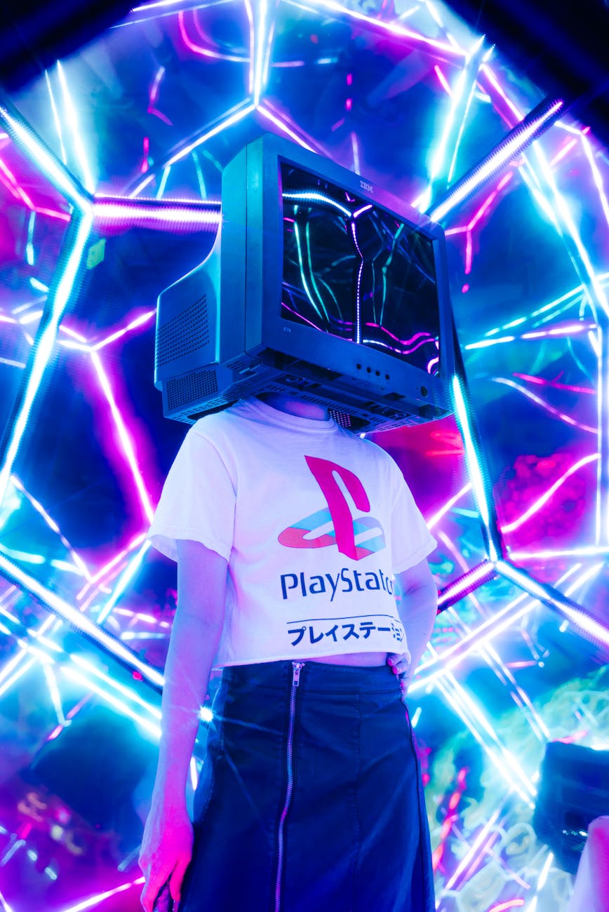 person wearing tv on their head standing inside kaleidoscope